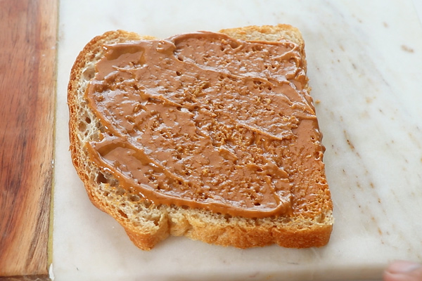 spread peanut butter on a slice