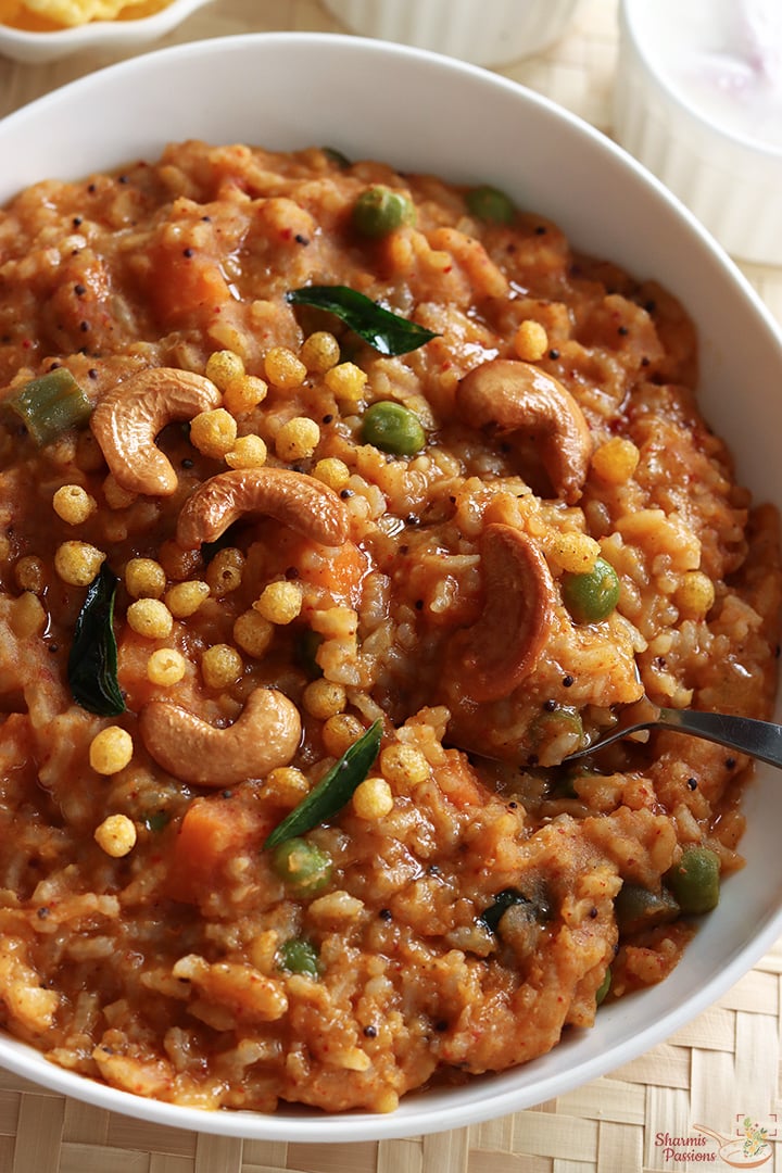 bisi bele bath serve with raita, boondi and papad