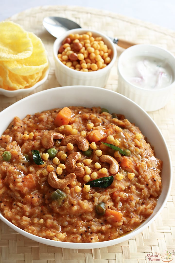bisi bele bath serve with raita, boondi and papad