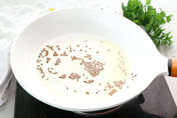 heat oil, temper cumin seeds