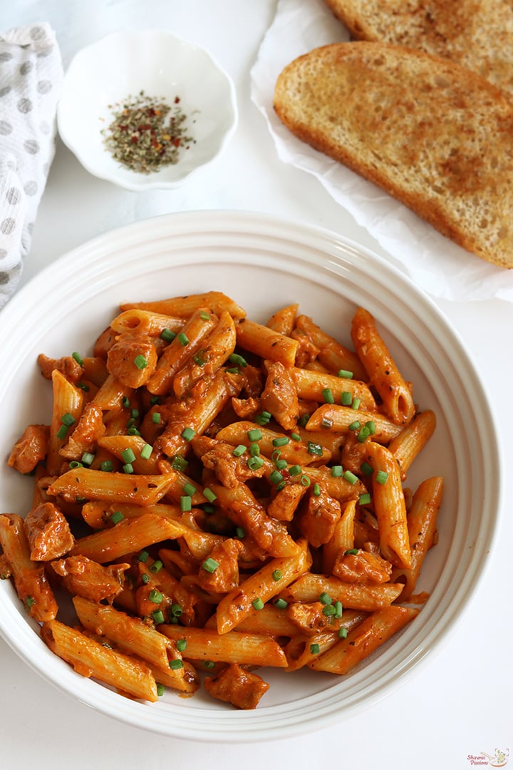 chicken pasta served with toasted bread and mixed herbs