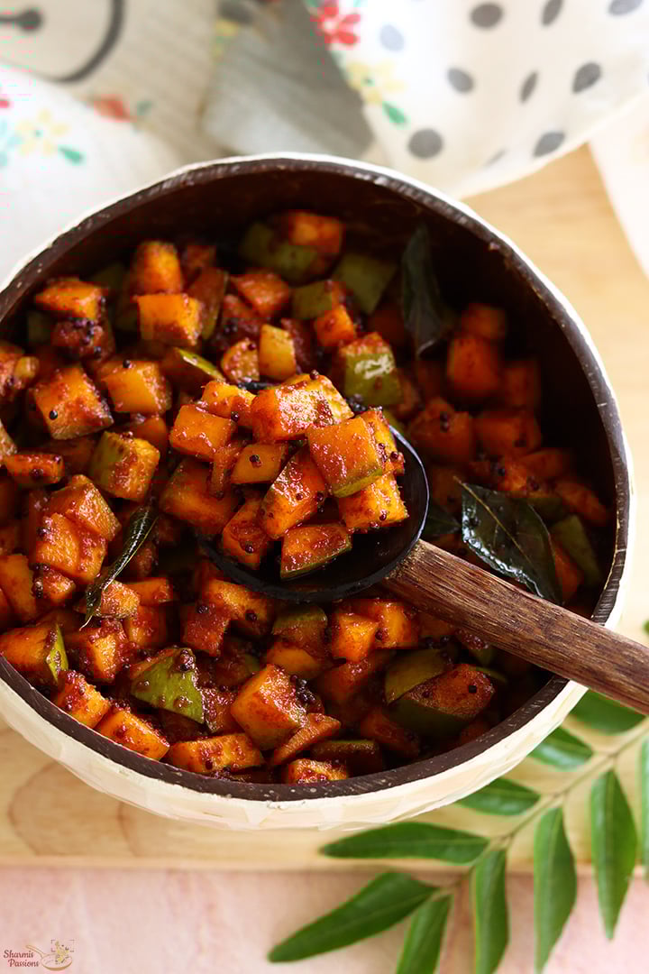 kadumanga achar served in a coconut shell bowl