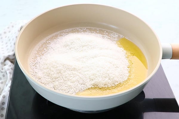 heat ghee, add desiccated coconut