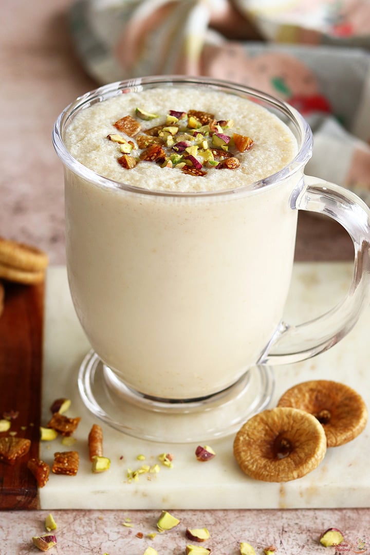 fig milkshake served with chopped nuts, figs in a glass