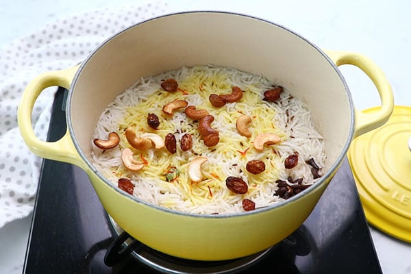 add saffron milk, cashews, raisins